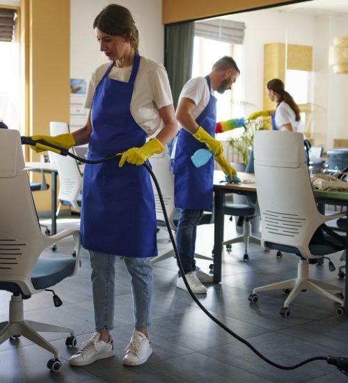 professional-cleaning-service-person-using-vacuum-cleaner-office